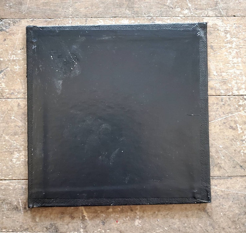 May include: A black canvas with a textured surface. The canvas is stretched and ready for painting.