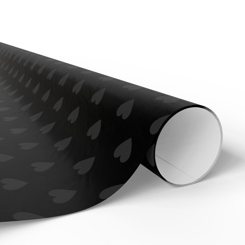 May include: A roll of black wrapping paper with a repeating pattern of grey hearts.