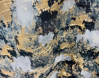 May include: Abstract fabric with a gold, black, and gray pattern. The fabric has a textured, woven look.