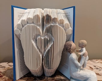 Baby feet with heart folded book