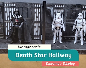 May include: A Death Star hallway diorama with vintage scale figures of Darth Vader and two Stormtroopers. The backdrop is dark gray with vertical and horizontal paneling. The text "Death Star Hallway" is displayed on a teal banner.