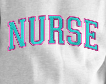 May include: A white sweatshirt with the word "NURSE" embroidered in turquoise blue with a pink outline.