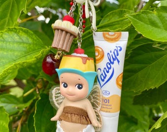 更新保留中、価格は正確ではありません。ソニーエンジェルのキーホルダー/バッグチャーム（ラノリップス リップバーム付き、グレーズドドーナツ）