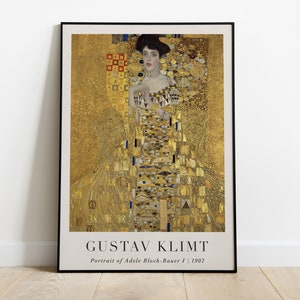 Könnte beinhalten: Ein Poster von Gustav Klimts Gemälde "Porträt von Adele Bloch-Bauer I", das eine Frau in einem goldenen Kleid vor einem goldenen Hintergrund zeigt. Das Gemälde ist ein berühmtes Beispiel für Klimts Jugendstil.