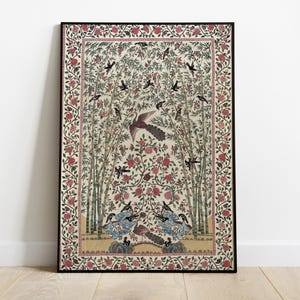 May include: A framed print of a vintage Indian textile design featuring a central floral motif with birds and a peacock, surrounded by a border of floral patterns in shades of pink, red, and green.