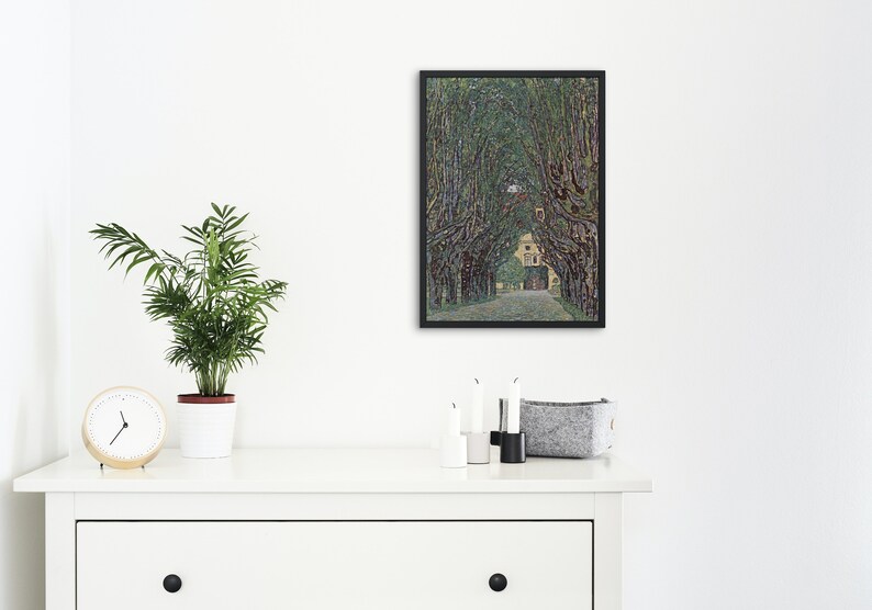 May include: A framed painting of a tree-lined path leading to a building. The trees are green and the building is yellow. The painting is in a black frame.