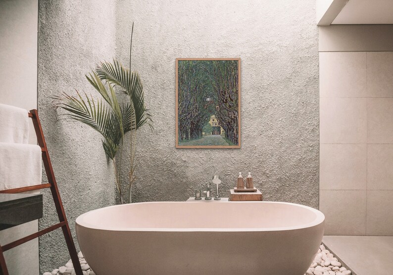 May include: A white bathtub with a wooden ladder and a framed painting of a green tree-lined path leading to a yellow house.
