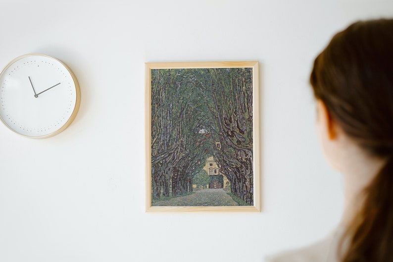 May include: A framed print of a painting depicting a tree-lined path leading to a building. The trees are painted in a pointillist style, with small dots of color creating the image.