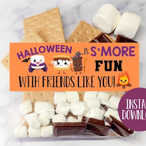 May include: Orange and purple Halloween-themed printable gift tag with the text "Halloween is S'more Fun with Friends Like You!" and a cartoon image of a marshmallow, graham cracker, and chocolate bar. The tag is next to a clear plastic bag filled with graham crackers, marshmallows, and chocolate squares.