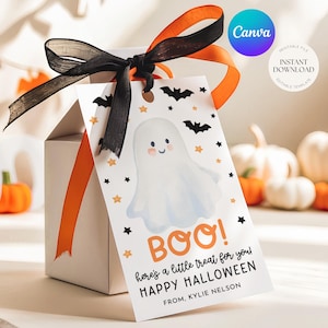 May include: A white gift box with orange ribbon and a black bow. A tag with a cartoon ghost, bats, and stars reads "BOO! here's a little treat for you! HAPPY HALLOWEEN FROM, KYLIE NELSON". The Canva logo is visible.