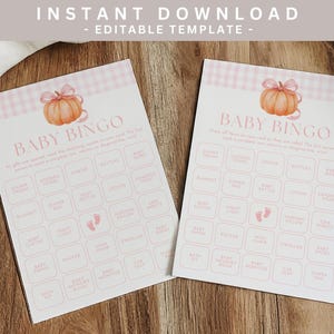 May include: Two baby bingo cards with a pumpkin illustration and pink gingham border. The cards have a grid of baby-related words. The text "Baby Bingo" is at the top of the card. The words "Instant Download - Editable Template" are at the top.