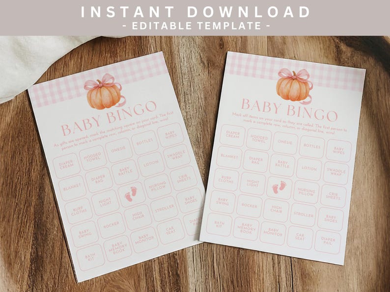 May include: Two baby bingo cards with a pumpkin illustration and pink gingham border. The cards have a grid of baby-related words. The text "Baby Bingo" is at the top of the card. The words "Instant Download - Editable Template" are at the top.