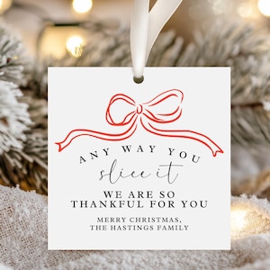 May include: White gift tag with a red ribbon bow and the text "ANY WAY YOU slice it WE ARE SO THANKFUL FOR YOU MERRY CHRISTMAS, THE HASTINGS FAMILY".