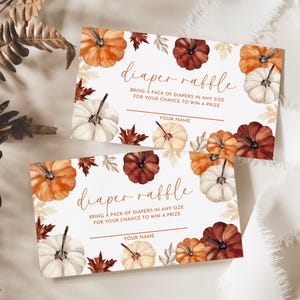 May include: Two diaper raffle cards with watercolor pumpkins in shades of orange, white, and burgundy, surrounded by fall leaves. The cards read "diaper raffle" and include space for a name.