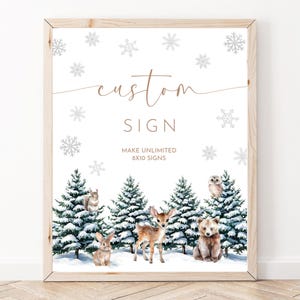 May include: A framed print with a winter forest scene, featuring woodland animals and snowflakes. The text at the top reads "custom SIGN". The bottom text reads "MAKE UNLIMITED 8x10 SIGNS". The frame is made of light-colored wood.