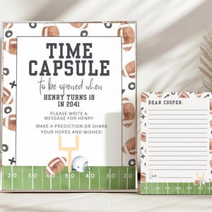 May include: A white card with a green and brown football theme. The card says "Time Capsule to be opened when Henry turns 18 in 2041". There is a smaller white card with lines for writing a message to Henry.