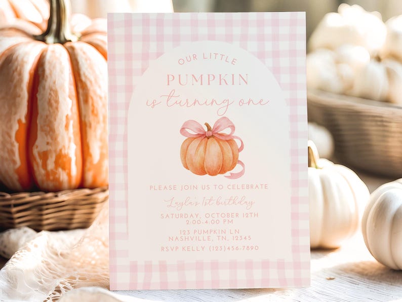 May include: A pink and white gingham-patterned invitation card with the text "Our Little Pumpkin is turning one." A watercolour illustration of a pumpkin with a pink bow is featured. The card includes party details.