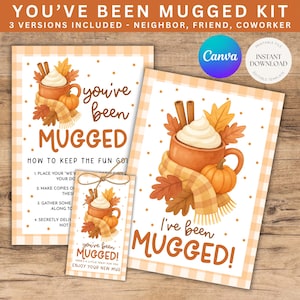 May include: Printable "You've Been Mugged" kit with three versions. The design features a coffee mug with whipped cream, cinnamon sticks, and autumn leaves. The text "You've Been Mugged" is displayed in a playful font, with instructions and a gift tag.