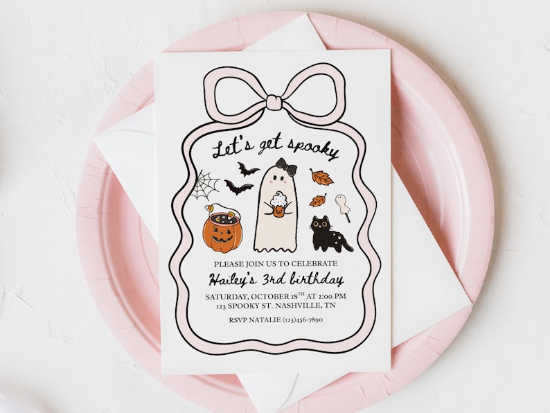 May include: A Halloween-themed invitation with a pink bow design. The invitation features a ghost, black cat, pumpkin, and the text "Let's get spooky" and "Hailey's 3rd birthday". The invitation is on a pink plate.
