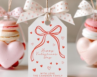 May include: White gift tag with a red bow and hearts, with the text "Happy Valentine's Day" and "With love, The Cameron Family".