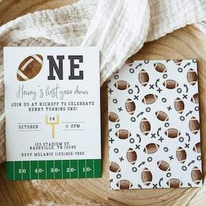 May include: A green and white football-themed invitation for a first birthday party. The invitation features a football graphic, the number "ONE", and the text "Henry's first year down". The invitation also includes the date, time, and RSVP information.