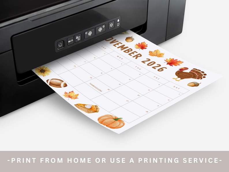 May include: A black printer printing a November 2026 calendar. The calendar features Thanksgiving-themed illustrations, including a turkey, pumpkin, and autumn leaves. The text at the bottom reads: -PRINT FROM HOME OR USE A PRINTING SERVICE-.