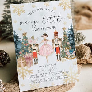 May include: A white invitation card with gold snowflakes and a watercolour illustration of a Nutcracker, a ballerina, and a mouse. The text reads "Please join us for a merry little baby shower in honour of Clara Nelson, December 19, 2024, 2:00 PM, 123 Christmas St, New York, NY, RSVP/Jessica (123) 456-7890, Clara is registered at Amazon."