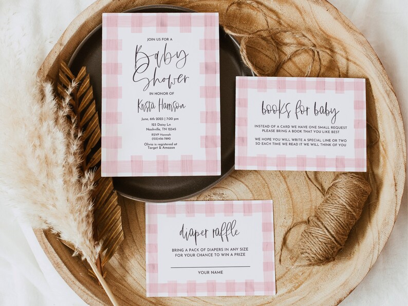 May include: Pink and white gingham baby shower invitation with the text "Join us for a baby shower in honor of Krista Hamson" and details about the event. There are also two additional cards with the text "books for baby" and "diaper raffle".