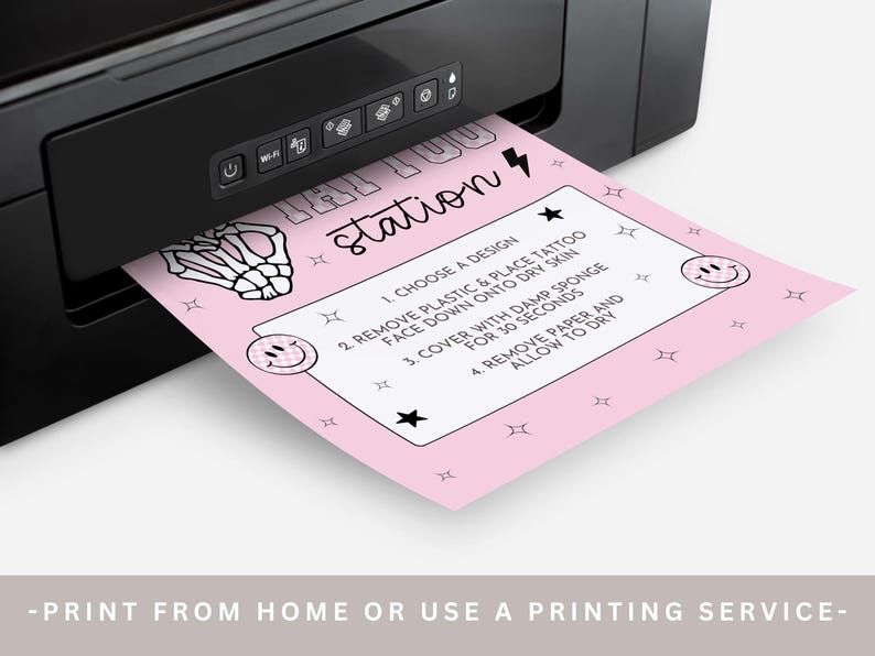 May include: A pink sheet with temporary tattoo instructions emerges from a black printer. The sheet features the word "station" and steps for application. The instructions include choosing a design, removing plastic, and allowing the tattoo to dry.