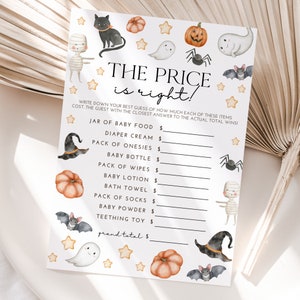 May include: A printable Halloween-themed baby shower game called "The Price is Right!" with a list of baby items and a space to write down the price guess. The game features cute illustrations of ghosts, bats, spiders, pumpkins, and witches.
