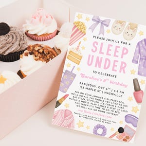 May include: A pink box filled with cupcakes and a sleepover invitation. The invitation reads "Sleep Under" and includes illustrations of pajamas, slippers, and nail polish. The cupcakes have various toppings, including cookies and nuts.