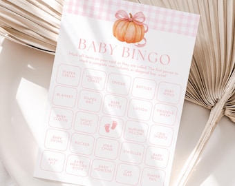 May include: A baby bingo game card with a pink gingham pattern and a watercolour pumpkin illustration. The card features a grid of baby-related items like nappies, bottles, and a stroller. The text "BABY BINGO" is at the top.