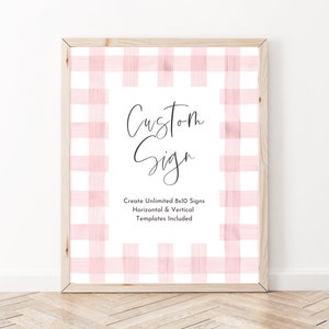 May include: A framed printable sign with a pink and white gingham pattern. The sign says "Custom Sign" and "Create Unlimited 8x10 Signs Horizontal & Vertical Templates Included".