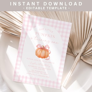 May include: A pink and white checked invitation card with the text "OUR LITTLE PUMPKIN is turning one." It features a watercolour pumpkin illustration with a pink bow. The card includes event details.