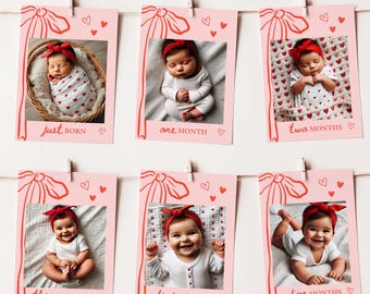 May include: Six pink photo cards with red bows and hearts, each featuring a baby in a different pose. The cards are labeled with the baby's age: Just Born, One Month, Two Months, Three Months, Four Months, and Five Months.