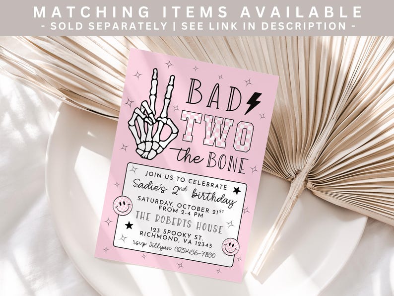 May include: A pink birthday invitation with the text "BAD TWO the BONE" and a skeleton hand making a peace sign. The invitation includes details for a second birthday party, including the date, time, and location.