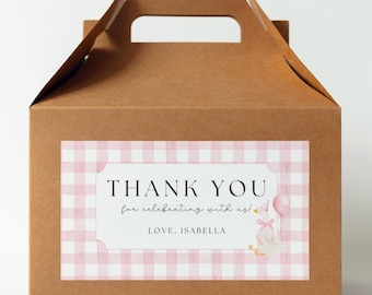May include: A brown cardboard box with a pink and white gingham pattern thank you tag. The tag says "Thank You for celebrating with us! Love, Isabella" and features a cartoon goose wearing a party hat and holding a balloon.