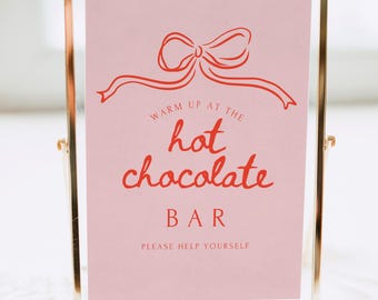 Può includere: Un cartello rosa con un fiocco rosso e il testo "Riscaldati al bar del cioccolato caldo. Serviti pure."