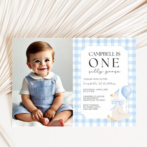 May include: A birthday invitation featuring a smiling baby in blue overalls next to a card with a blue gingham border. The card reads "Campbell is One" and includes event details and a goose illustration.