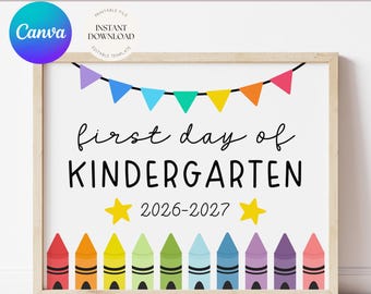 May include: A printable sign featuring a colorful bunting banner at the top, the black text first day of KINDERGARTEN, the year 2026-2027, two yellow stars, and a row of ten multi-colored crayons along the bottom edge on a white background.