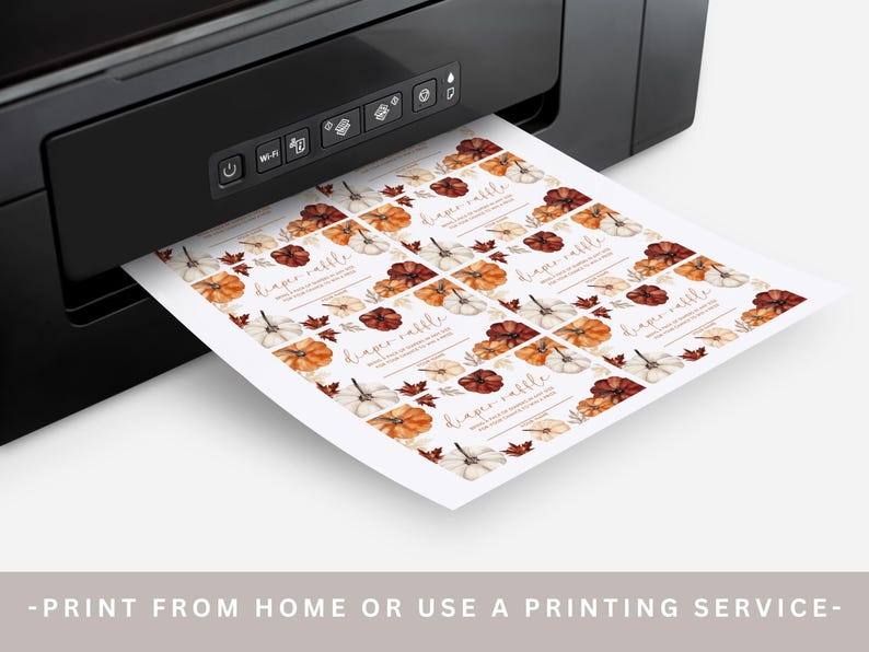 May include: A black printer is printing a sheet of paper with fall-themed diaper raffle cards. The cards feature watercolor pumpkins in shades of orange, white, and brown, with fall leaves. The text "diaper raffle" is visible on each card.