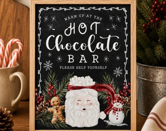 May include: A framed sign with a black chalkboard background featuring white text that reads WARM UP AT THE HOT CHOCOLATE BAR PLEASE HELP YOURSELF. The design includes illustrations of a Santa mug, a gingerbread person, and a snowman.