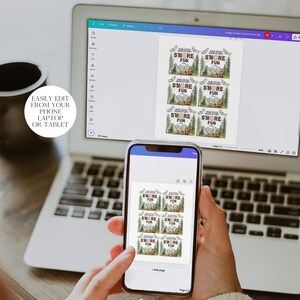 May include: A laptop computer screen displaying a digital design of six printable tags with a camping theme. The tags feature a brown tent, a campfire, and the text "SMORE FUN". A cell phone is in the foreground, displaying the same design on the screen.