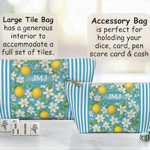 May include: Two zippered bags with a lemon and floral pattern. The bags have blue and white striped sides. The larger bag is labeled "Large Tile Bag" and the smaller bag is labeled "Accessory Bag". Mahjong tiles and dice are in front of the bags.