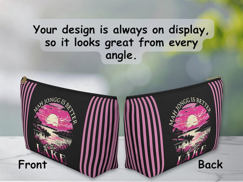 May include: Black zippered pouch with pink vertical stripes and a sunset graphic that reads "MAH JONGG IS BETTER at the LAKE." The text "Your design is always on display, so it looks great from every angle" is at the top.