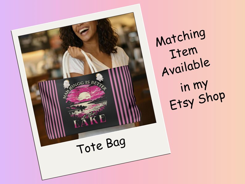 May include: Black tote bag with pink and black vertical stripes and a graphic of a sunset over a lake. Text on the bag reads "Mah Jongg is Better at the Lake". The image also includes the text "Matching Item Available in my Etsy Shop".