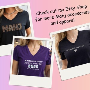 May include: Three V-neck t-shirts in black and purple, each with a different Mahjong-themed design. One shirt says "MAHJ mama" with a leopard print design. Another says "MAHJONG IS MY Retirement Plan". The third says "it's about bam time".
