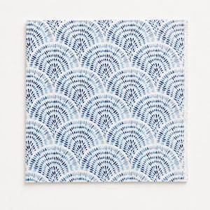 May include: A square napkin featuring a repeating fan-shaped pattern composed of small, dark blue and light blue brushstroke marks on a white background. The design creates a series of overlapping arches across the entire surface of the fabric.