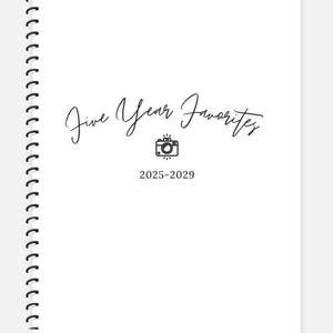 May include: A white spiral-bound notebook with the text "Five Year Favorites" in elegant script. Below the title is a camera icon and the years "2025-2029". The notebook's pages are blank.