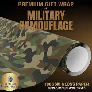 May include: A roll of gift wrap paper featuring a military camouflage pattern in shades of green, brown, and black. The text reads PREMIUM GIFT WRAP, MILITARY CAMOUFLAGE, 180GSM GLOSS PAPER, MADE AND PRINTED IN THE USA, and THE GIFT WRAP EMPORIUM.